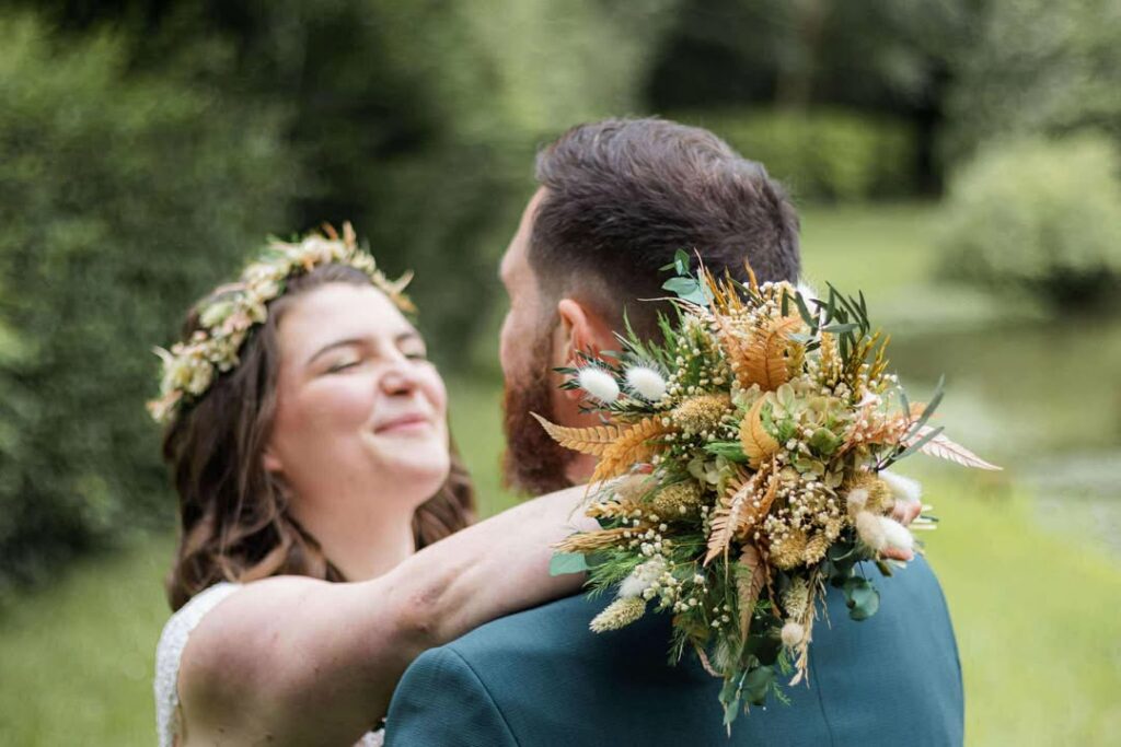 mariés avec un bouquets champêtre en fleurs séchées et staiblisées